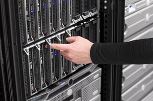 A person pressing a button on a server